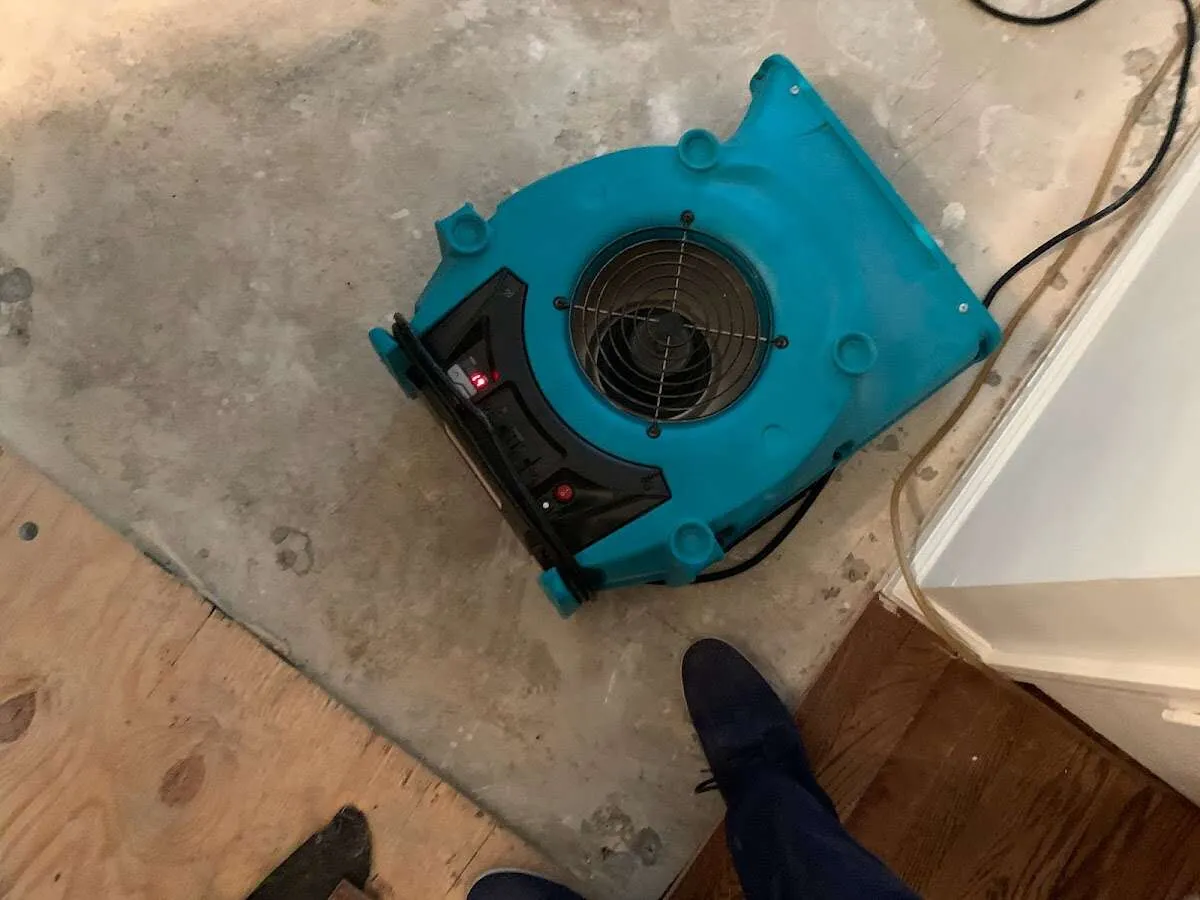 Air mover drying subfloor during Commercial Water Damage Restoration in Wonder Lake